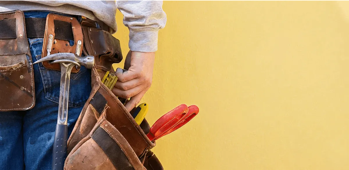 Handyman with tool belt ready for home repairs and maintenance in Staten Island, NY